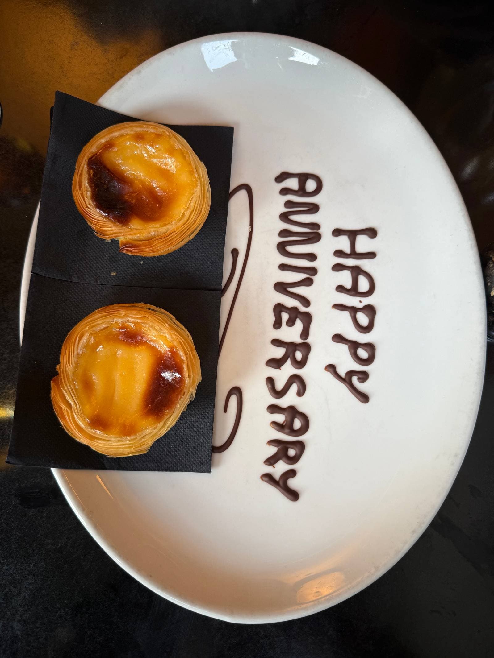 A celebration meal at Quinta with Portuguese tarts and a Happy Anniversary plate